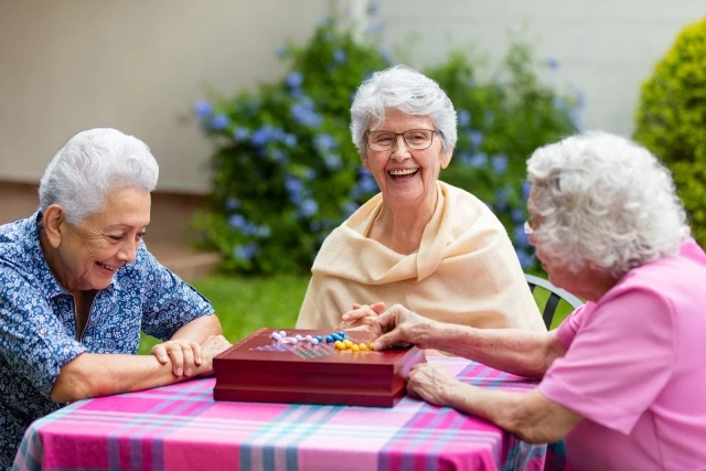 Senior women playing backgammon