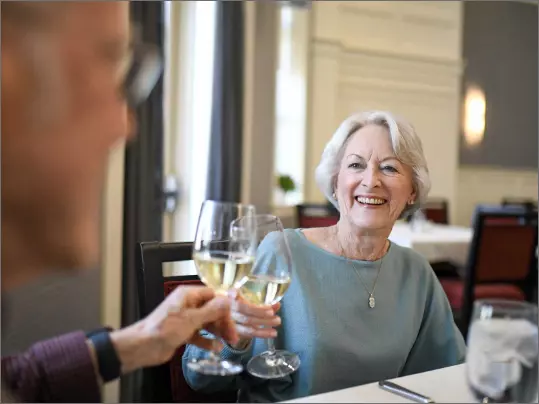 Senior couple toasting drinks