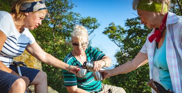 Older women drinking coffee outdoors