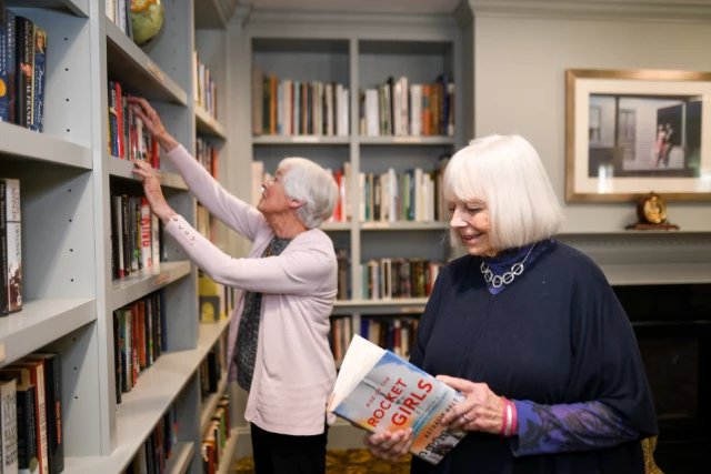 Senior woman reading in library