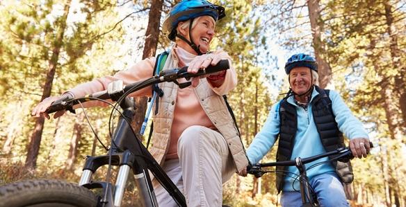 Seniors riding bikes in the woods