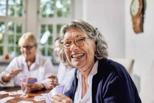 Senior women playing cards