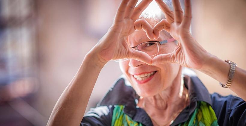 Senior woman making heart sign