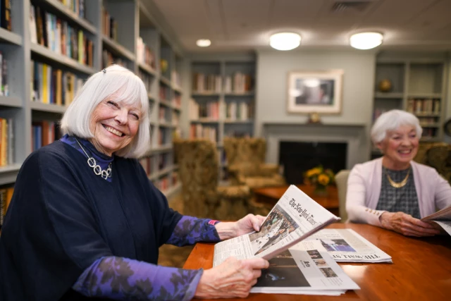 Senior woman holding newspaper