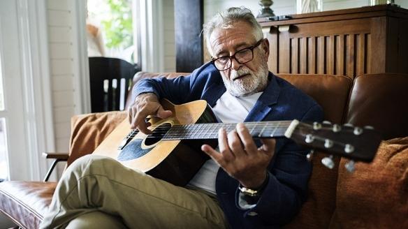 Senior man playing guitar