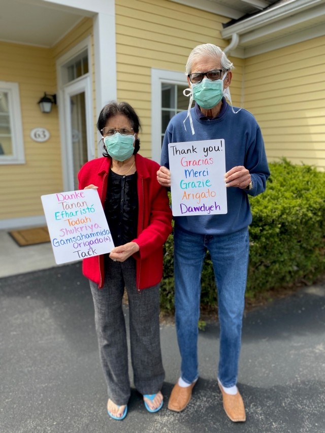 Senior couple holding Thank You signs