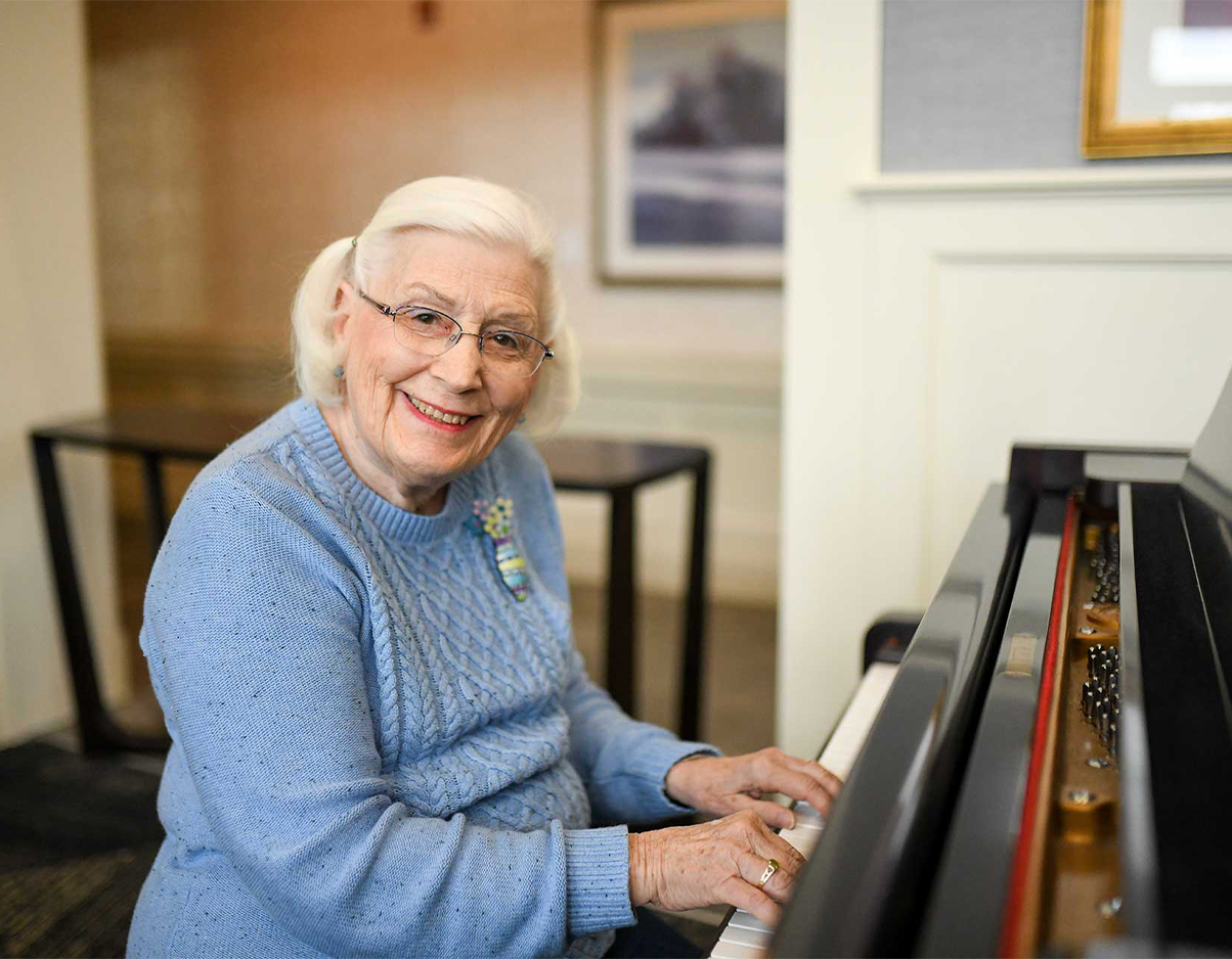 Resident Flo B. plays the piano in the dining room for residents to enjoy.