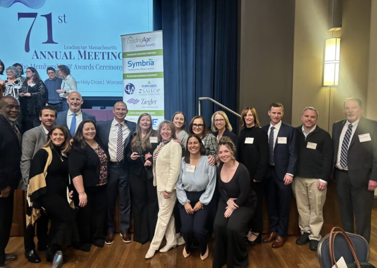 Robin McElligott celebrates receiving the 2025 Emerging Leader Award from LeadingAge Massachusetts, surrounded by colleagues and family at the annual meeting in Worcester.