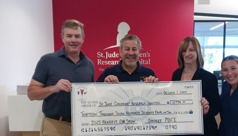 : Kara Davidson, second from right, presents a donation to St. Jude’s Children’s Research Hospital