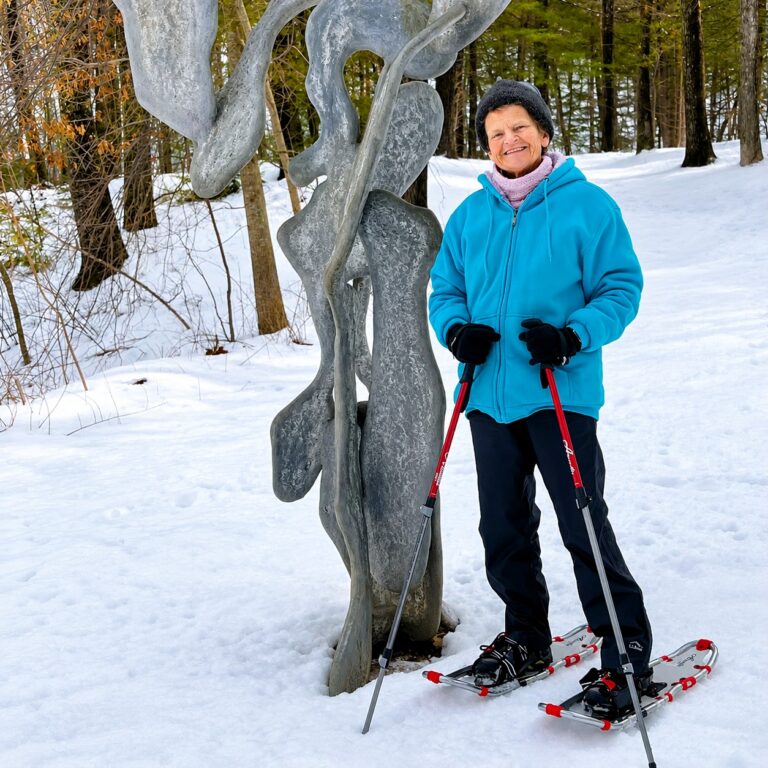 Resident Marilyn Morgan snowshoes beside a contemporary outdoor sculpture at deCordova Sculpture Park and Museum in Lincoln, Massachusetts.