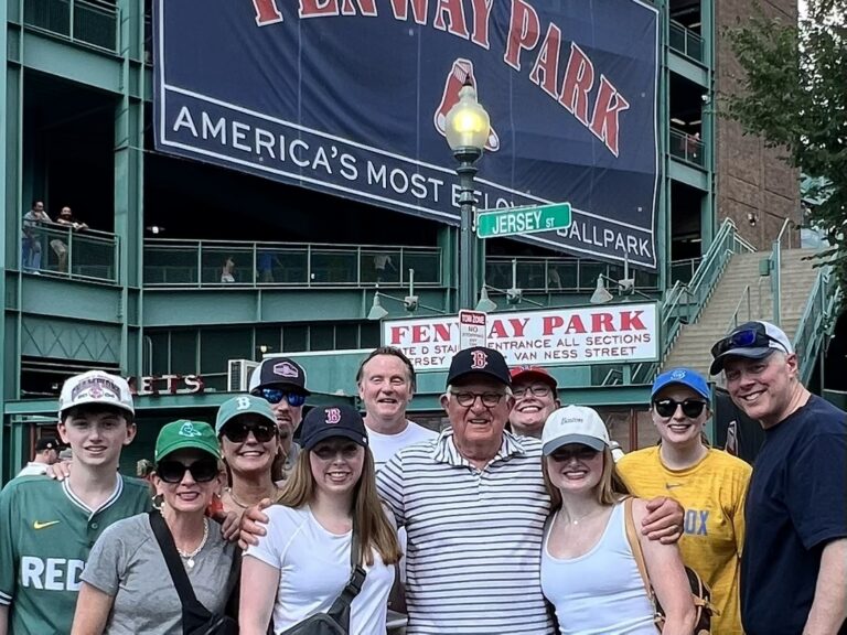 Terry R. stands with members of his extended family outside Fenway Park during a family outing to a Boston Red Sox game.