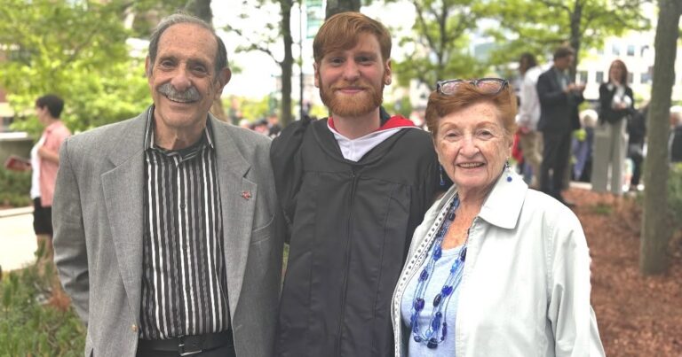 Stu and Ellen K. smile with their grandson Elias at his graduation from Clark University.
