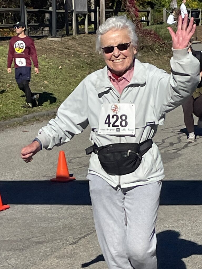 senior woman running in a road race.